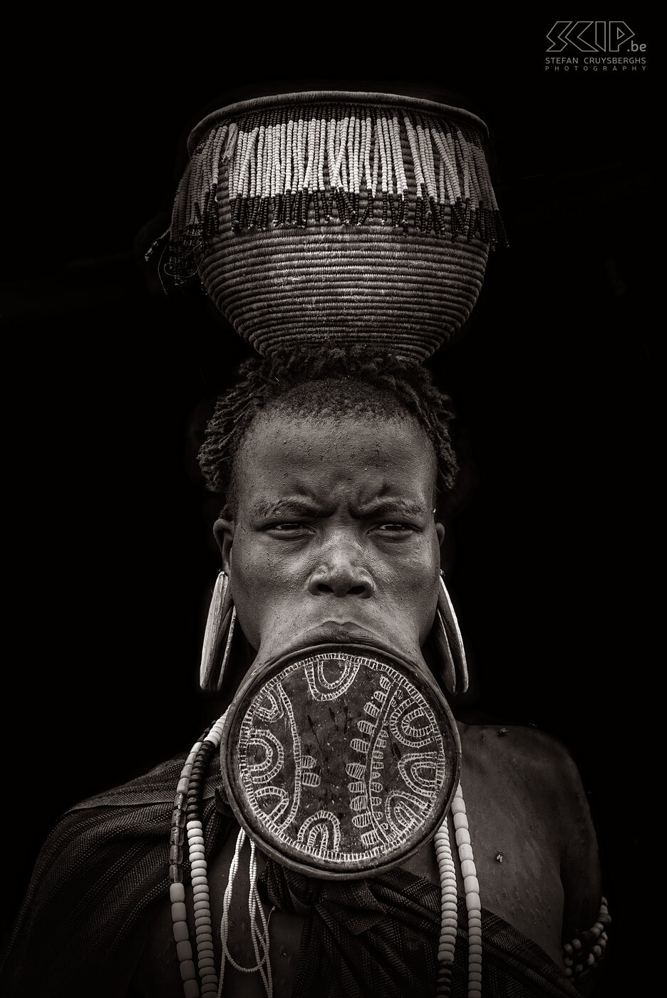 Mago - Mursi woman with impressive lip plate The lip plate is only worn by women and it is made from clay and inserted into a pierced hole in the lower lip. Some plates have a diameter of 23cm. The lip is pierced around the age of 15 or 18 before a women gets married. Stefan Cruysberghs